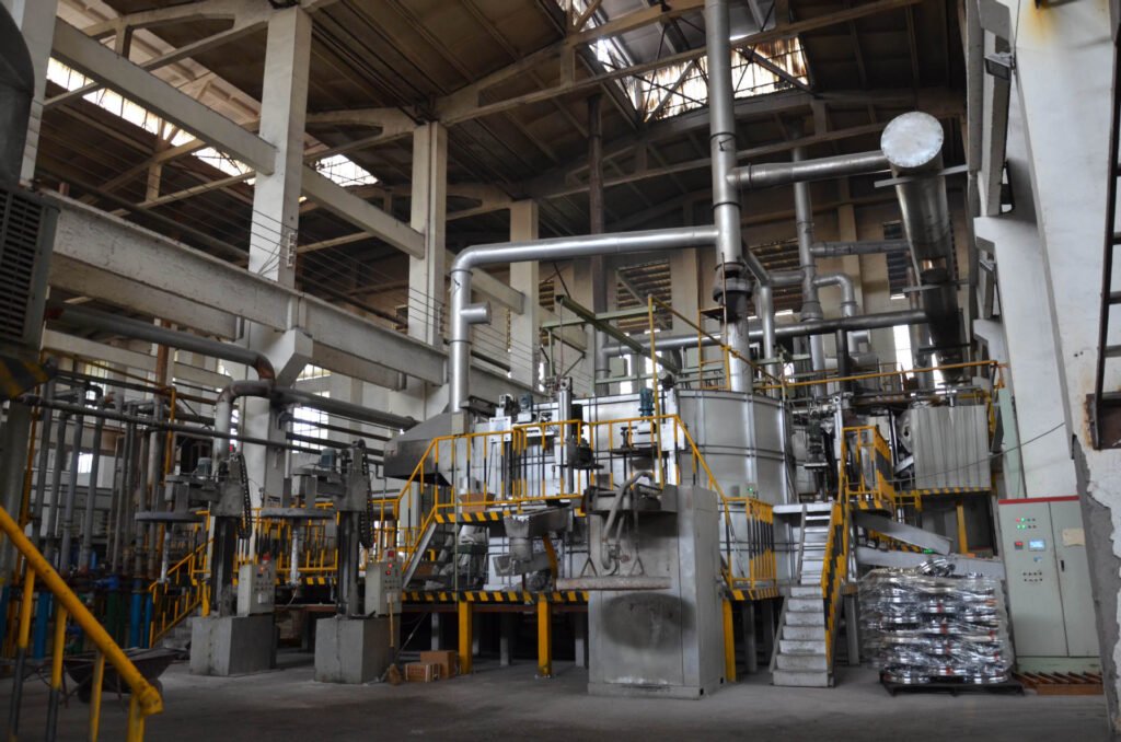 A cast wheel manufacturing process, showing molten aluminum being poured into a mold for gravity or low-pressure casting.