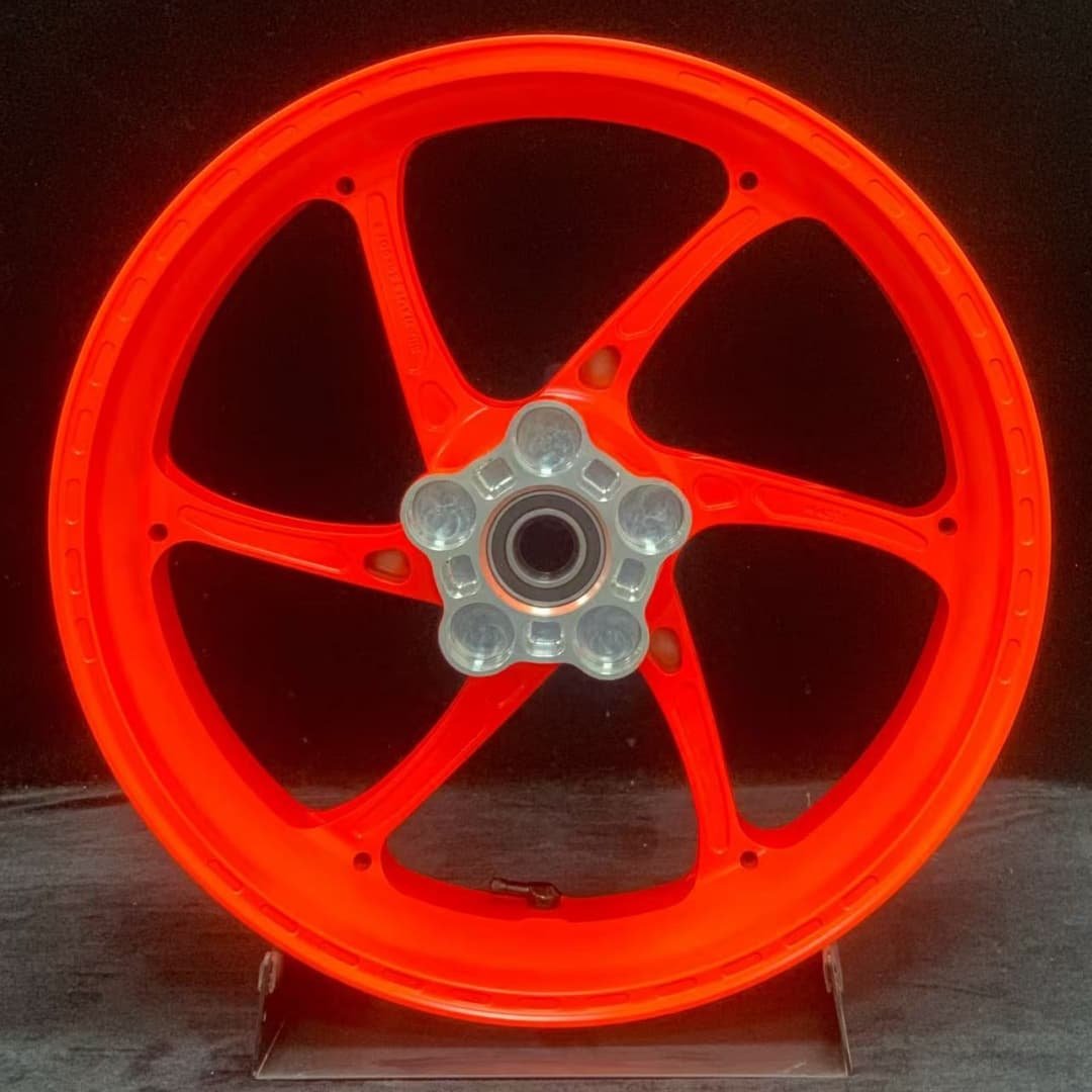 Forged rear wheel for KTM 790 / 890 with vibrant orange finish and precision CNC hub