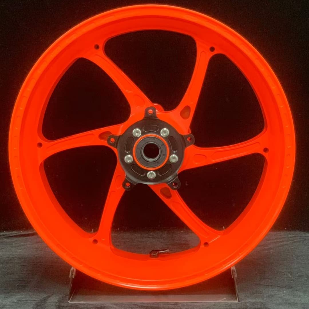 KTM 790 / 890 forged rear wheel with neon orange coating and dark hub center