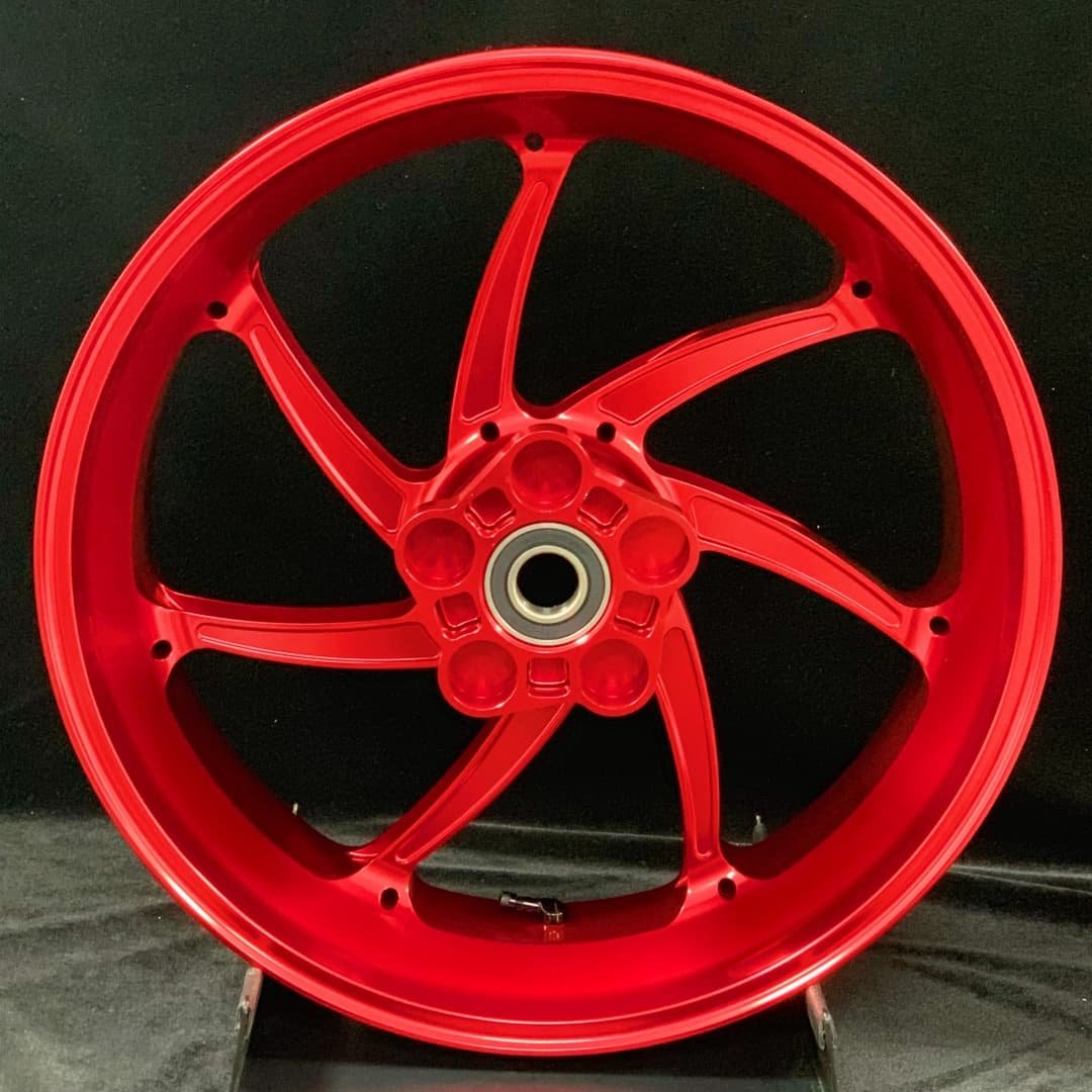Rear red forged wheel for BMW S1000RR motorcycle with aerodynamic CNC-machined 7-spoke layout