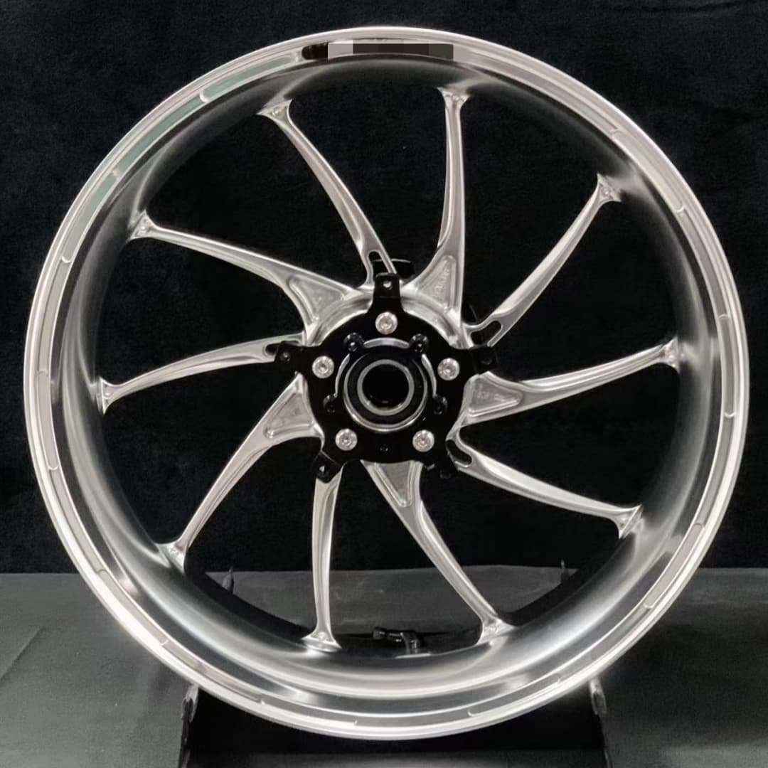 Polished forged rear motorcycle wheel for BMW R nineT with black hub and curved spoke design