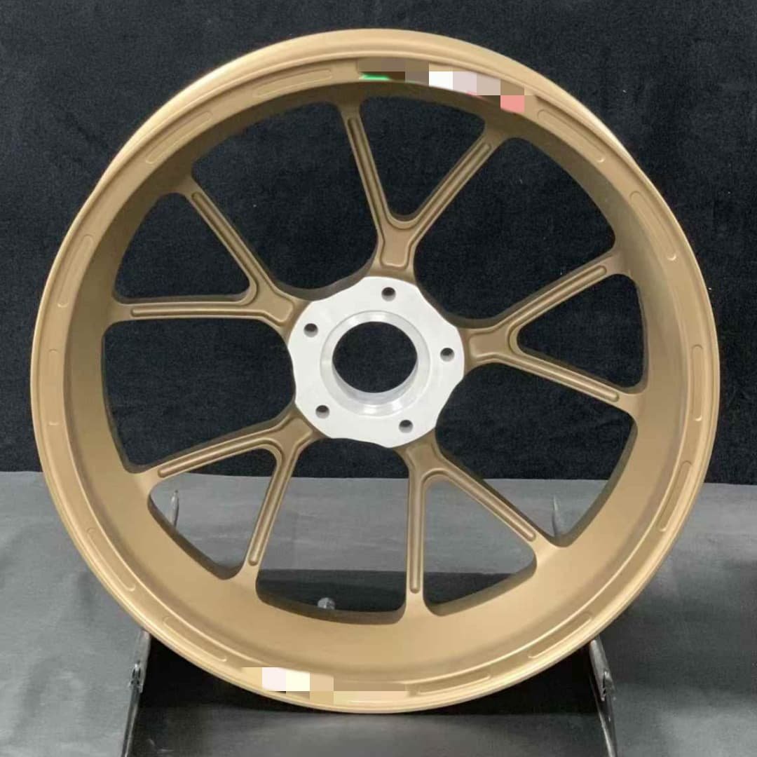 Custom bronze forged wheel for Aprilia motorcycles with silver hub and radial spoke pattern