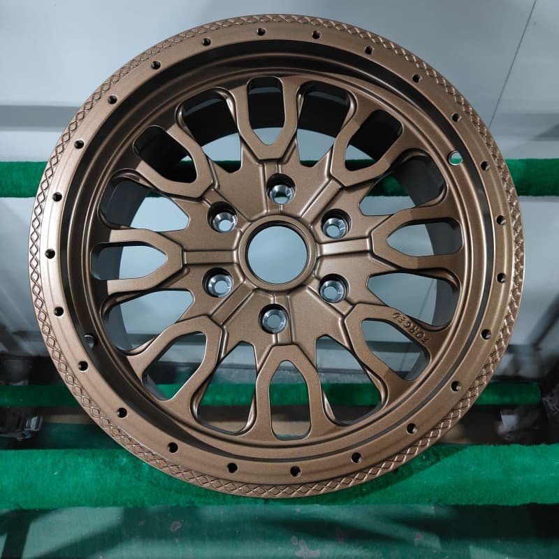 Forged black and silver beadlock off-road wheel with rugged split-spoke design and exposed hardware for 4x4 applications