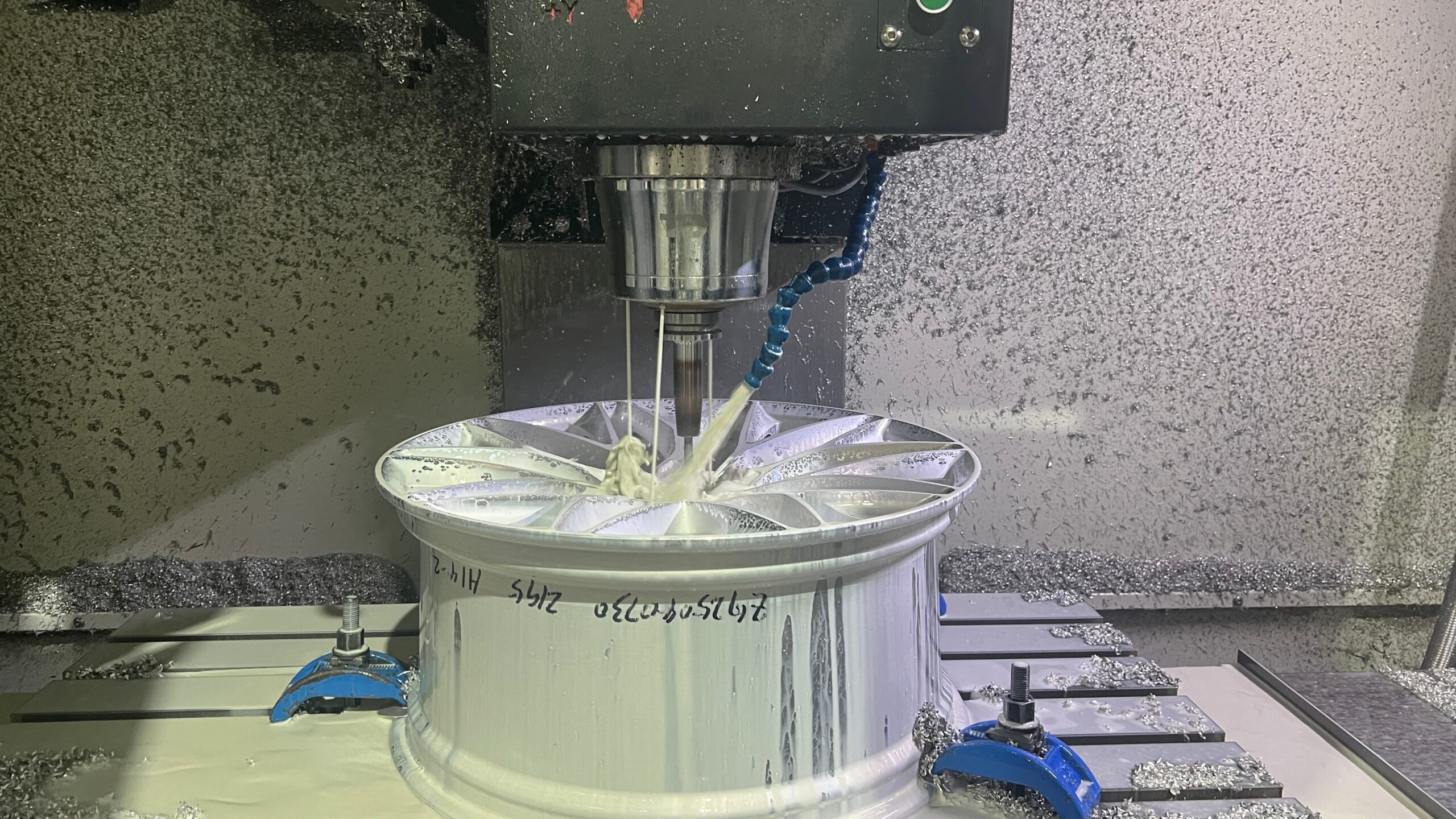 CNC machining the center bore of a 6061-T6 forged wheel at the FLEXIFORGED factory
