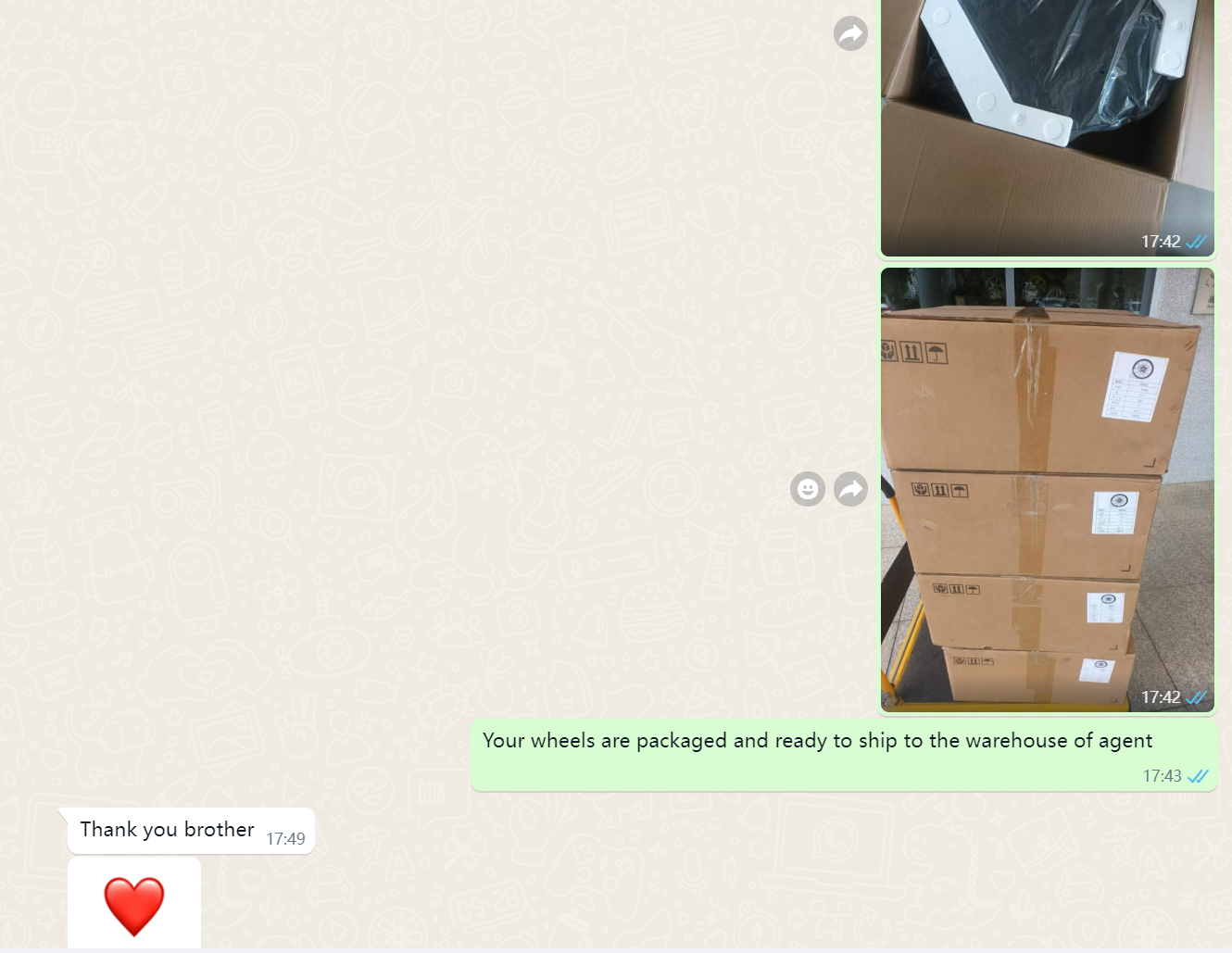 WhatsApp screenshot — foam-protected forged wheels packed in boxes and photographed before shipping