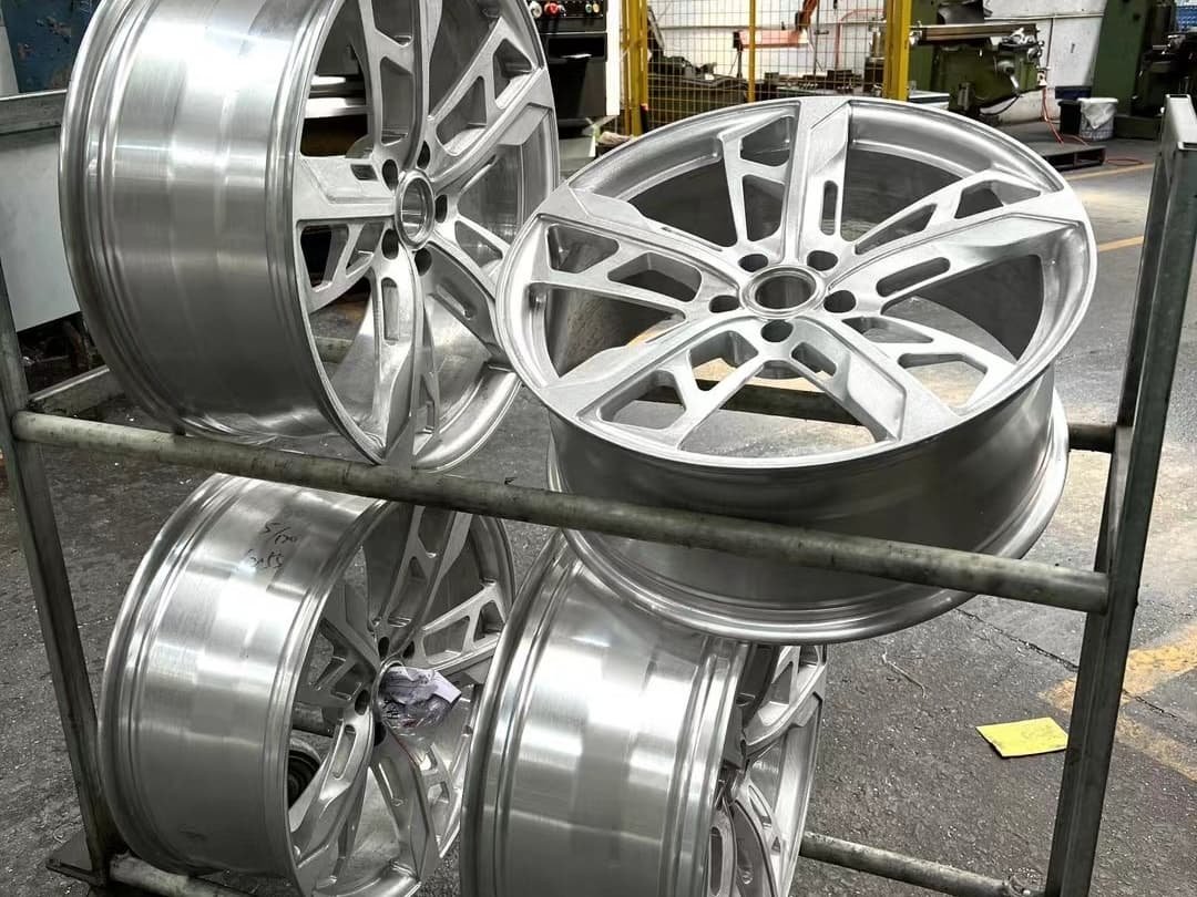 Finished custom forged wheels on racks awaiting inspection and packing at FLEXIFORGED