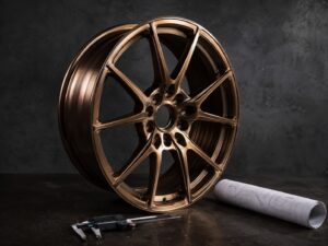 Forged monoblock wheel on an inspection bench with calipers and a technical drawing at the FLEXIFORGED forged wheel manufacturer facility
