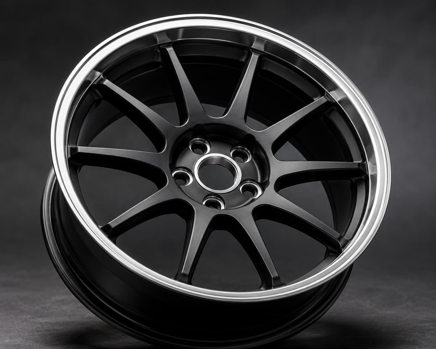 Gunmetal forged aluminium wheel with machined lip, five bolt holes and an open machined center bore — FLEXIFORGED